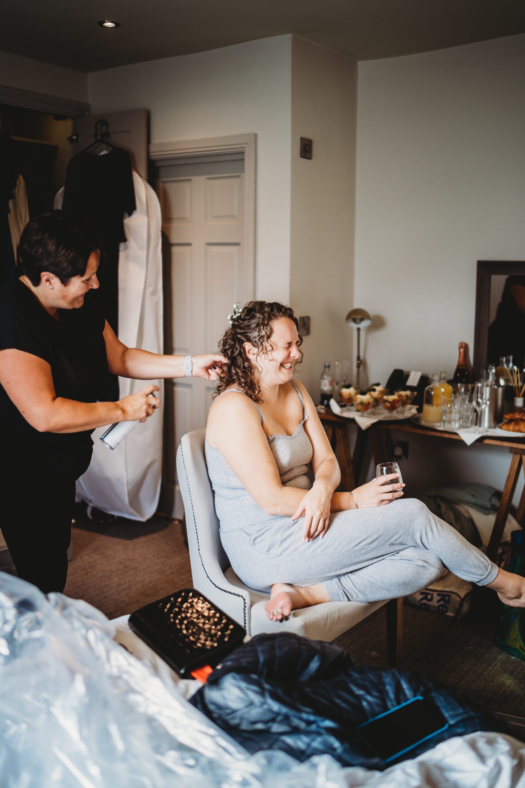 a bride laughing as shes getting ready for her wedding at The wellington Arms, hampshire