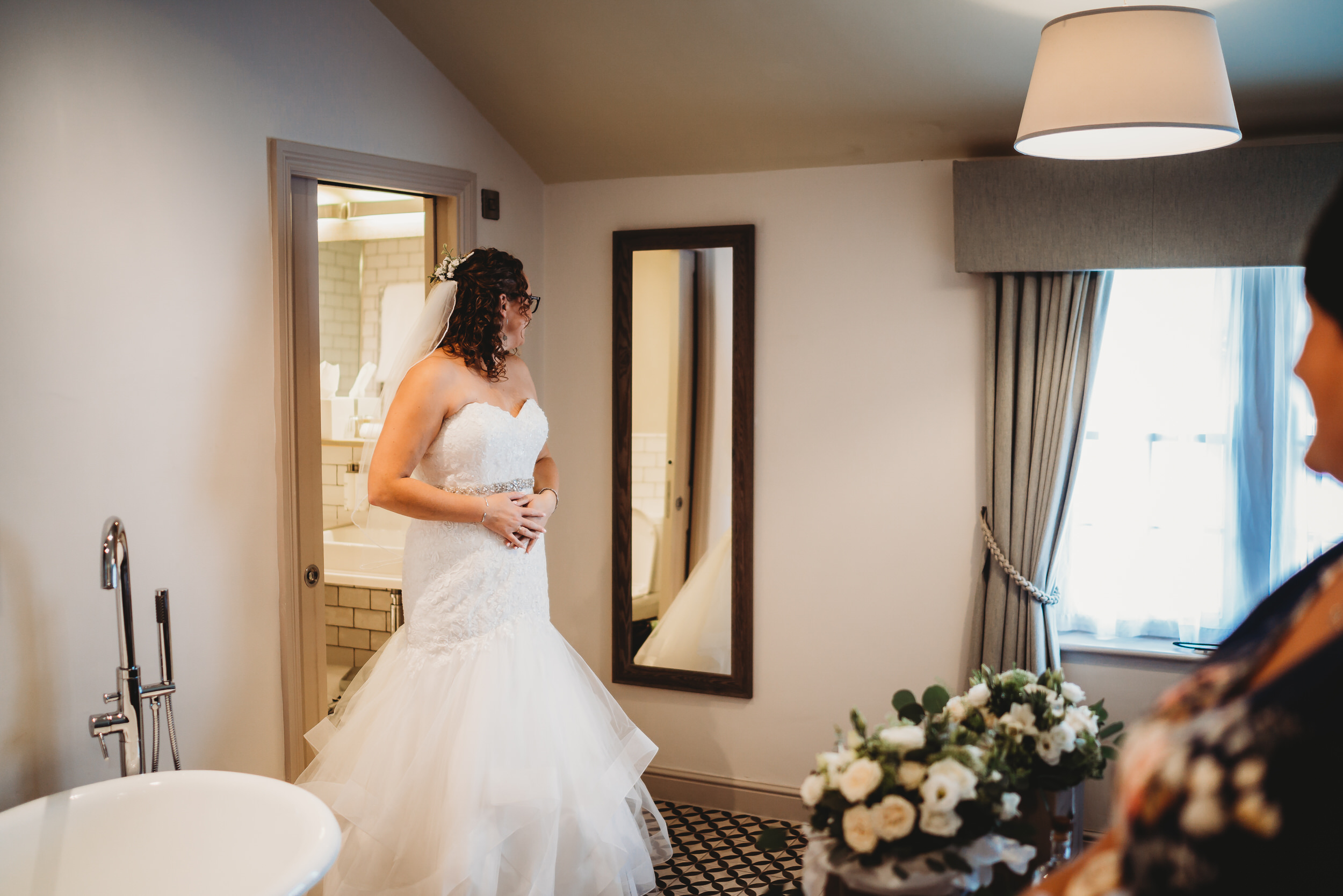 a bride looking at herself in a mirror taken by a hampshire wedding photographer
