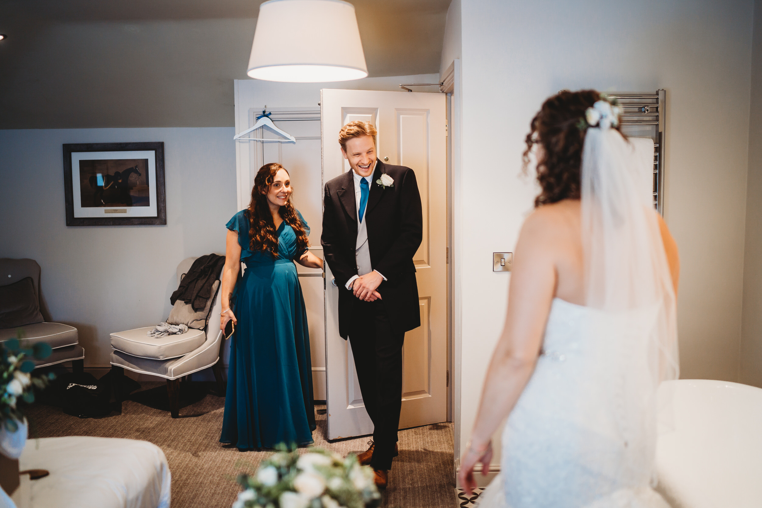 The bride meeting her brother before her wedding day as taken by a wedding photographer in Hampshire 