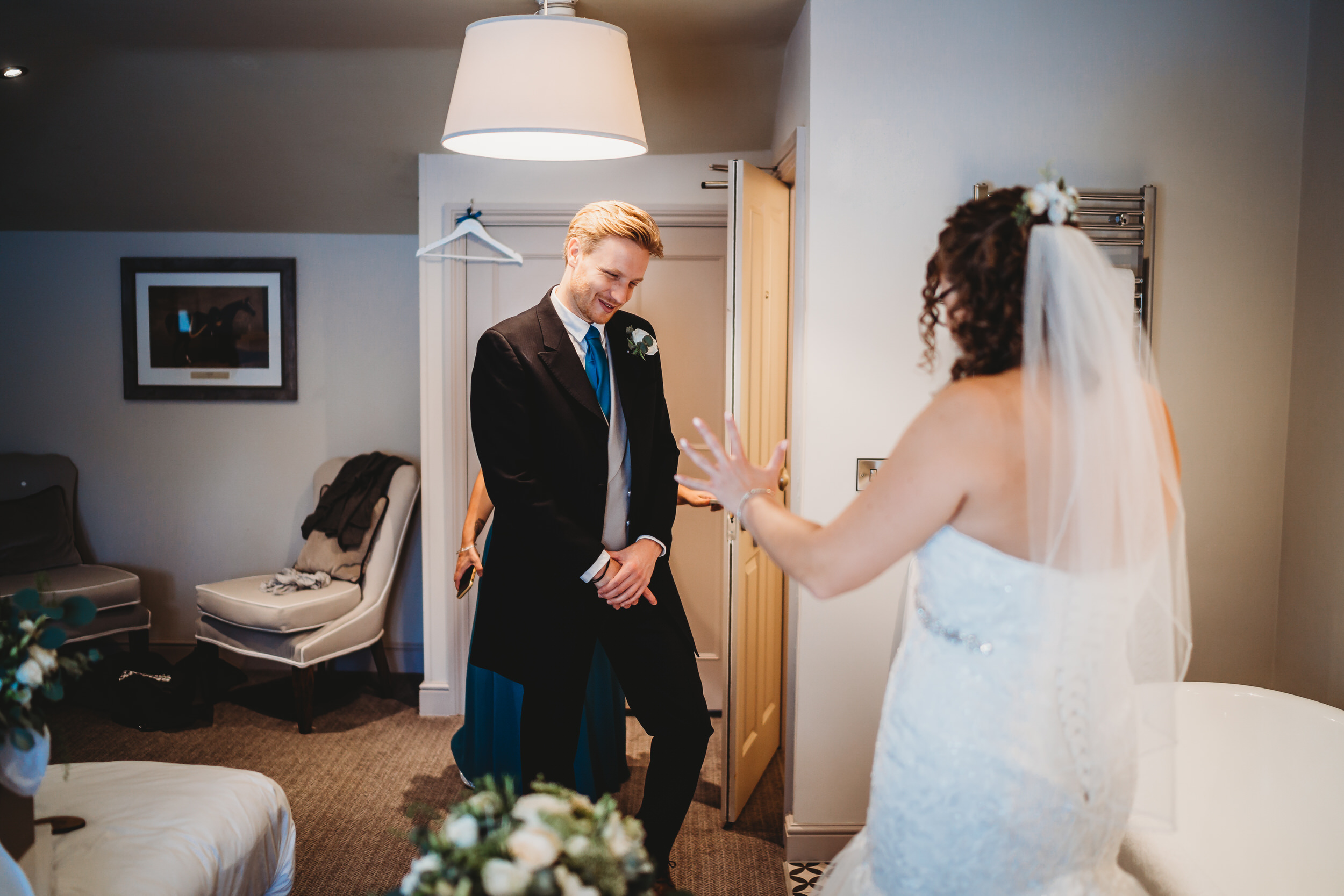 A brother affectionally looking at his sister ready for her wedding day