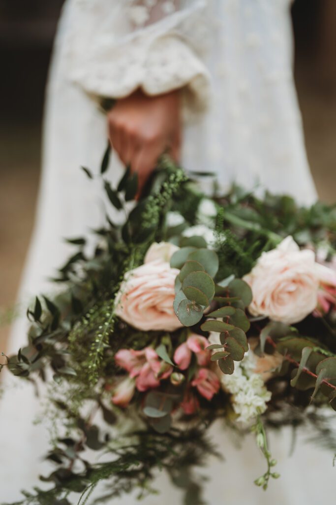 Festival wedding photography of a full wedding bouquet full of pink flowers and eucalyptus 