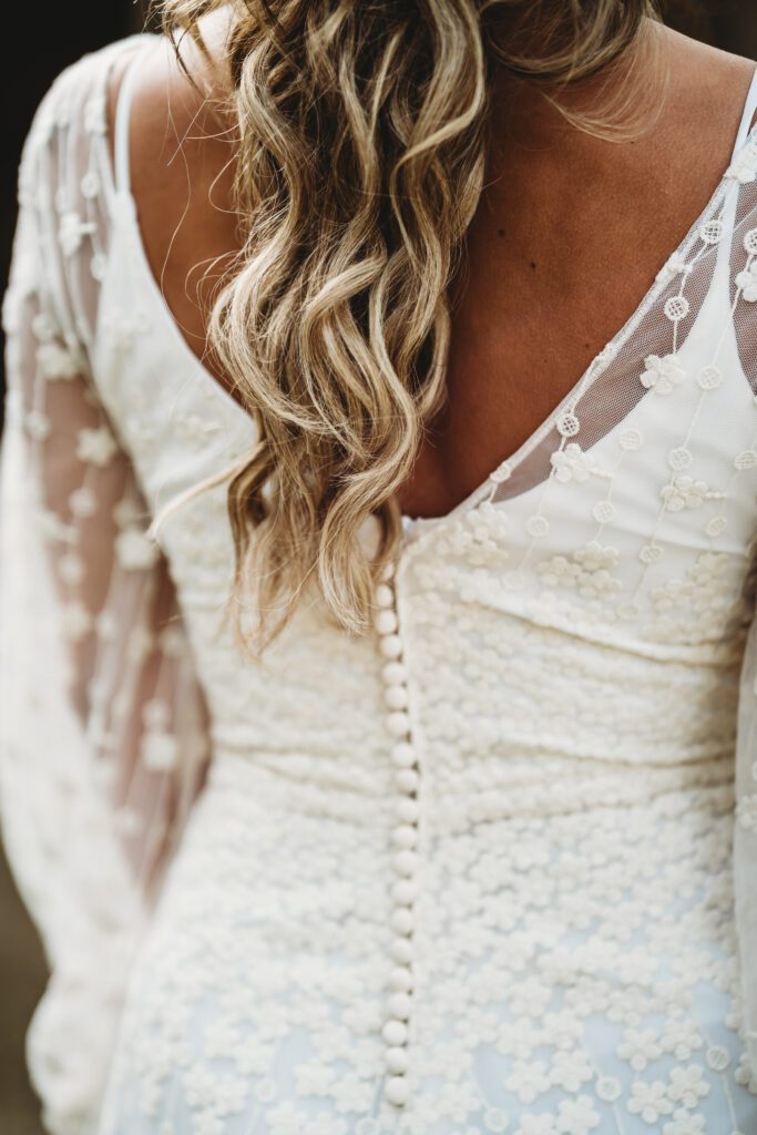 a detail image of the back of a bride with a boho themed dress