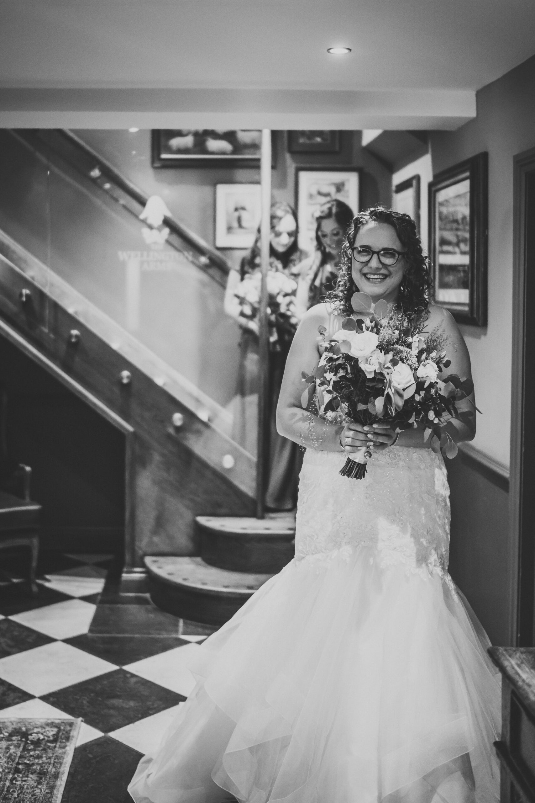 a bride and her bridesmaids walking towards her ceremony