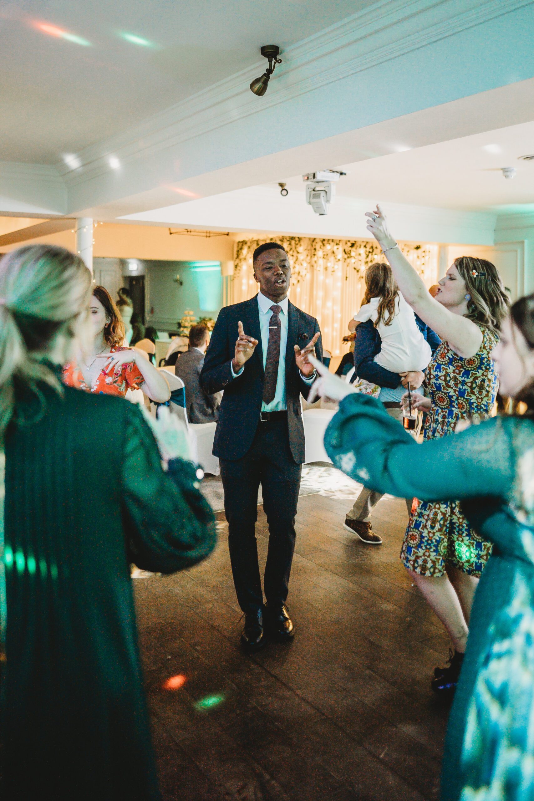 a man dancing during a wedding reception 