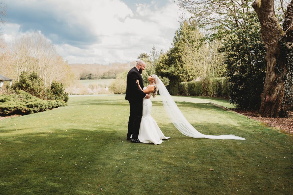 newly wed couple cuddling in front of a beautiful view