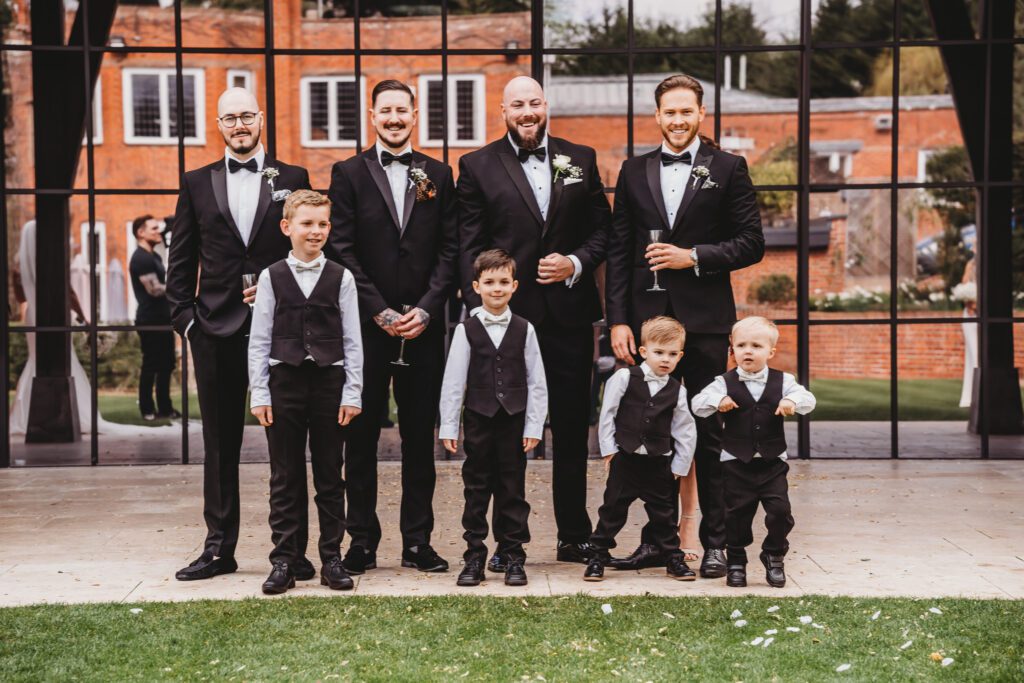 grooms men lined up for their group shot taken by a berkshire wedding photographer