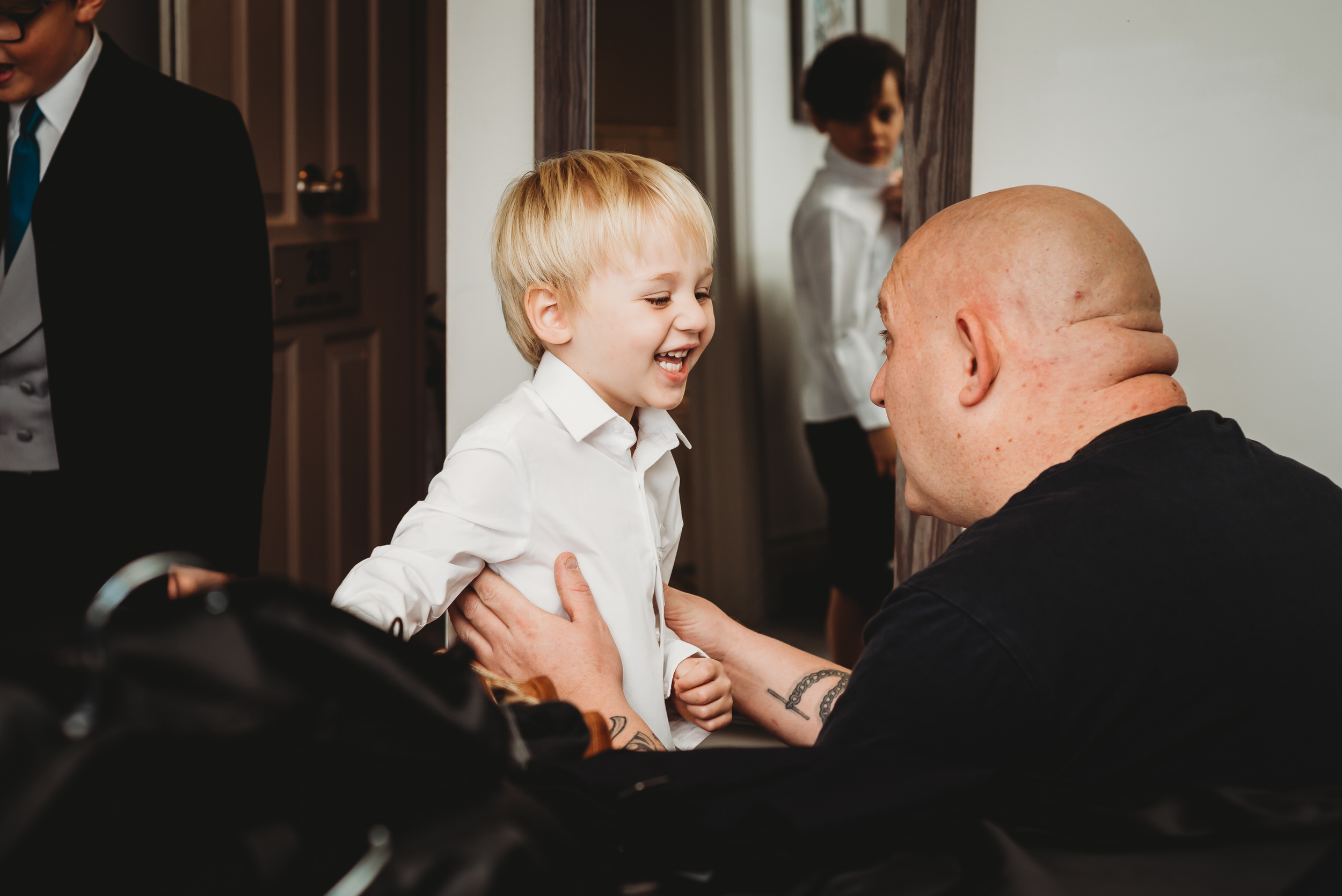 a page boy giggling as hes getting ready for his Dads wedding at The Wellington Arms