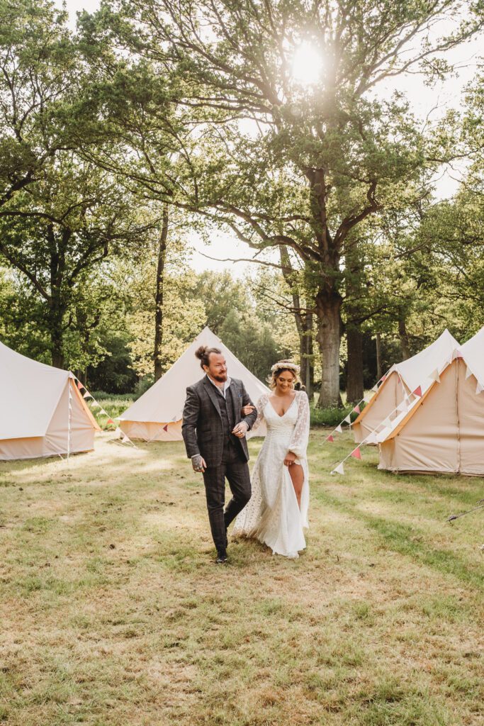 a bride and groom linking arms and walking for a festival wedding photographer 