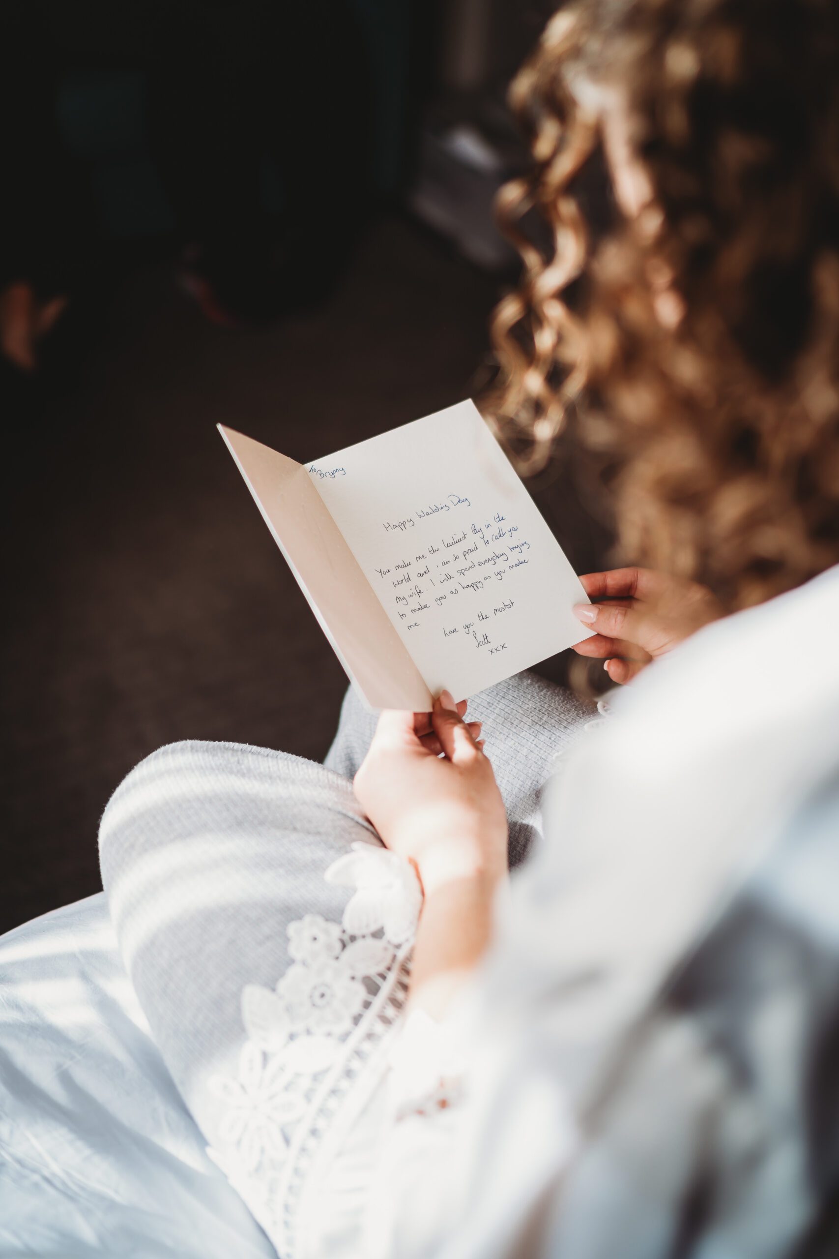 a bride reading a card from her husband to be for their hampshire wedding