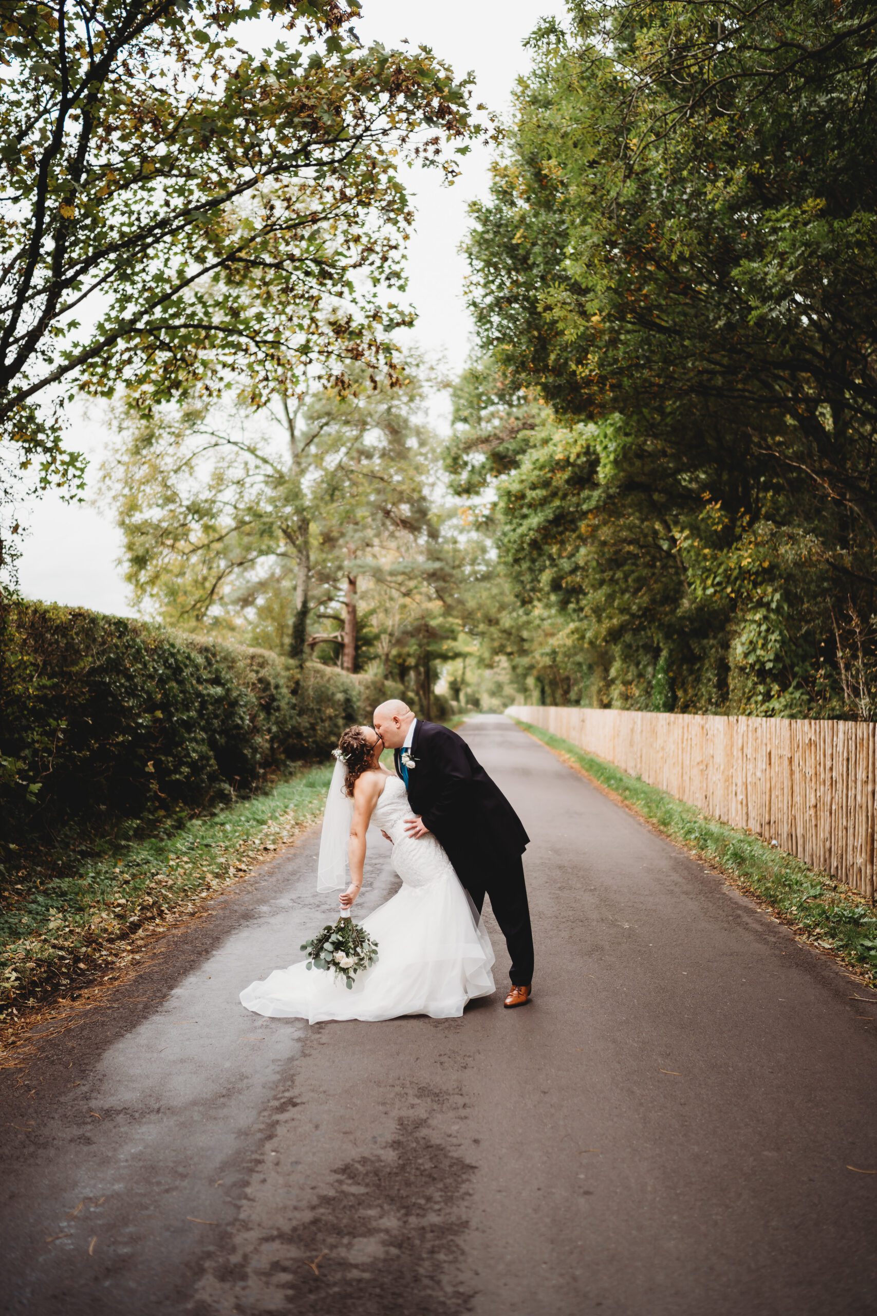 a bride and groom doing a drop kiss for a hampshire wedding photographer 