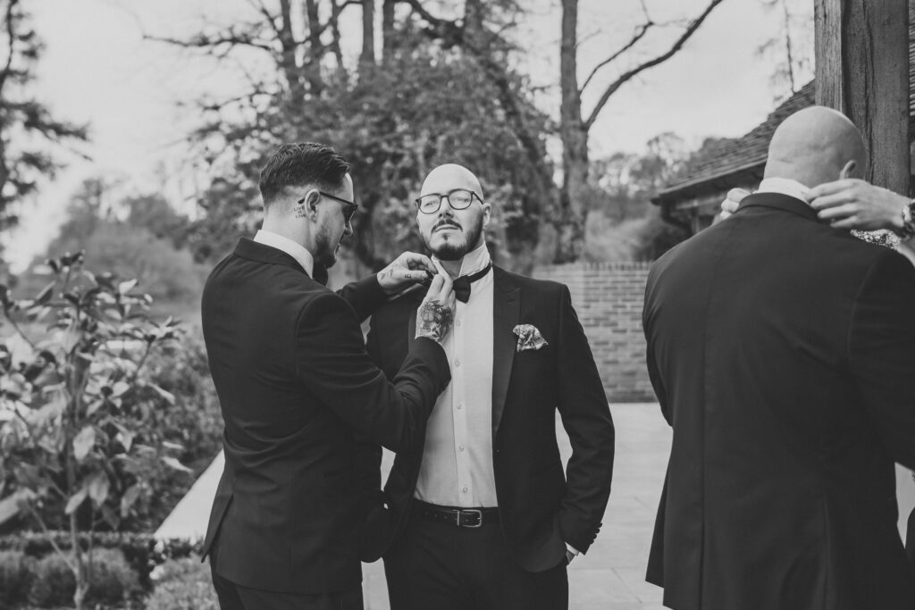 wedding photography of the grooms men getting ready at the post barn newbury