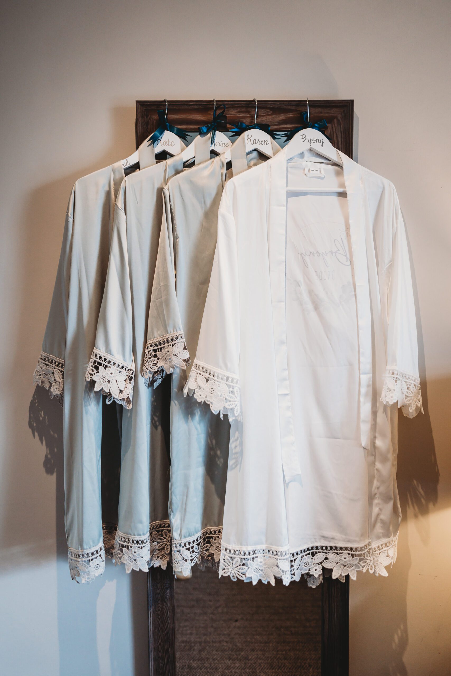 Bridal parties dressing gowns hung in a row for a Hampshire Wedding Photographer