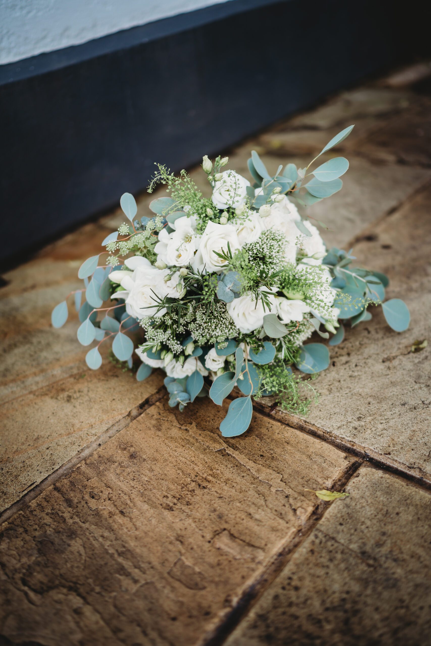 a brides white and green floral bouquet 