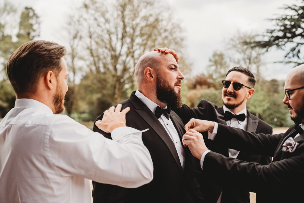 wedding photography of the grooms men getting ready at the post barn newbury