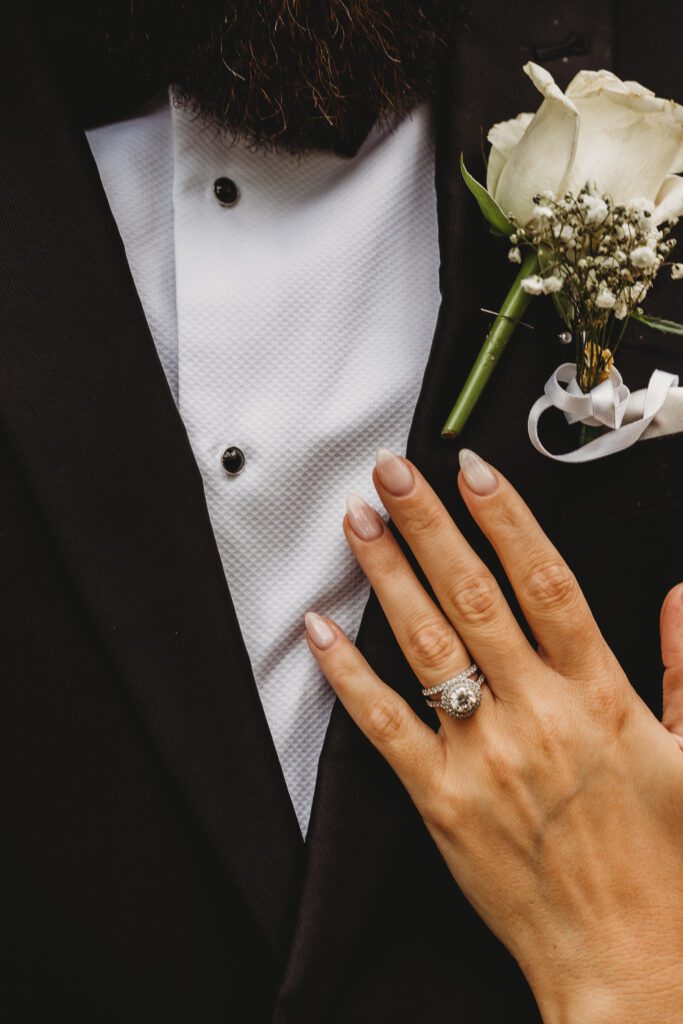 a brides hand showing off her new wedding ring 