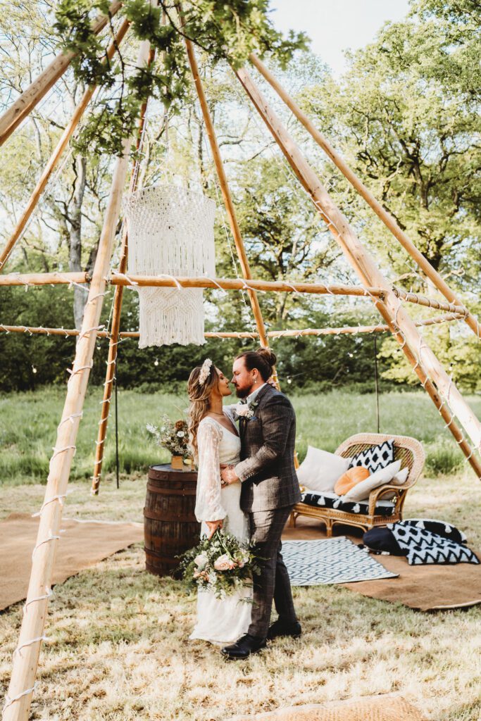 a newly wed husband and wife cuddling up together for a festival wedding photographer