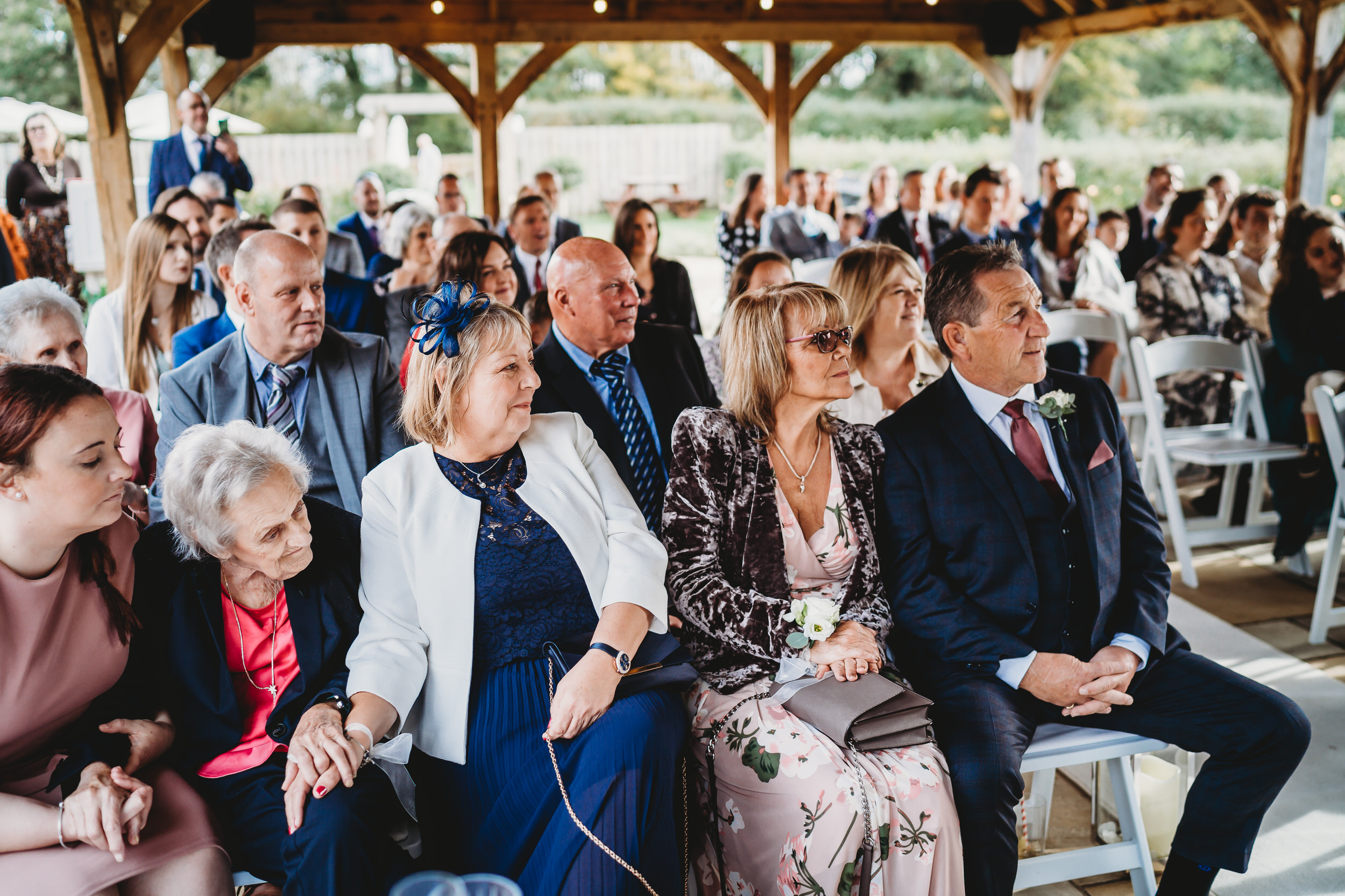 wedding guests looking on as a bride and groom exchange vows during a hampshire wedding 