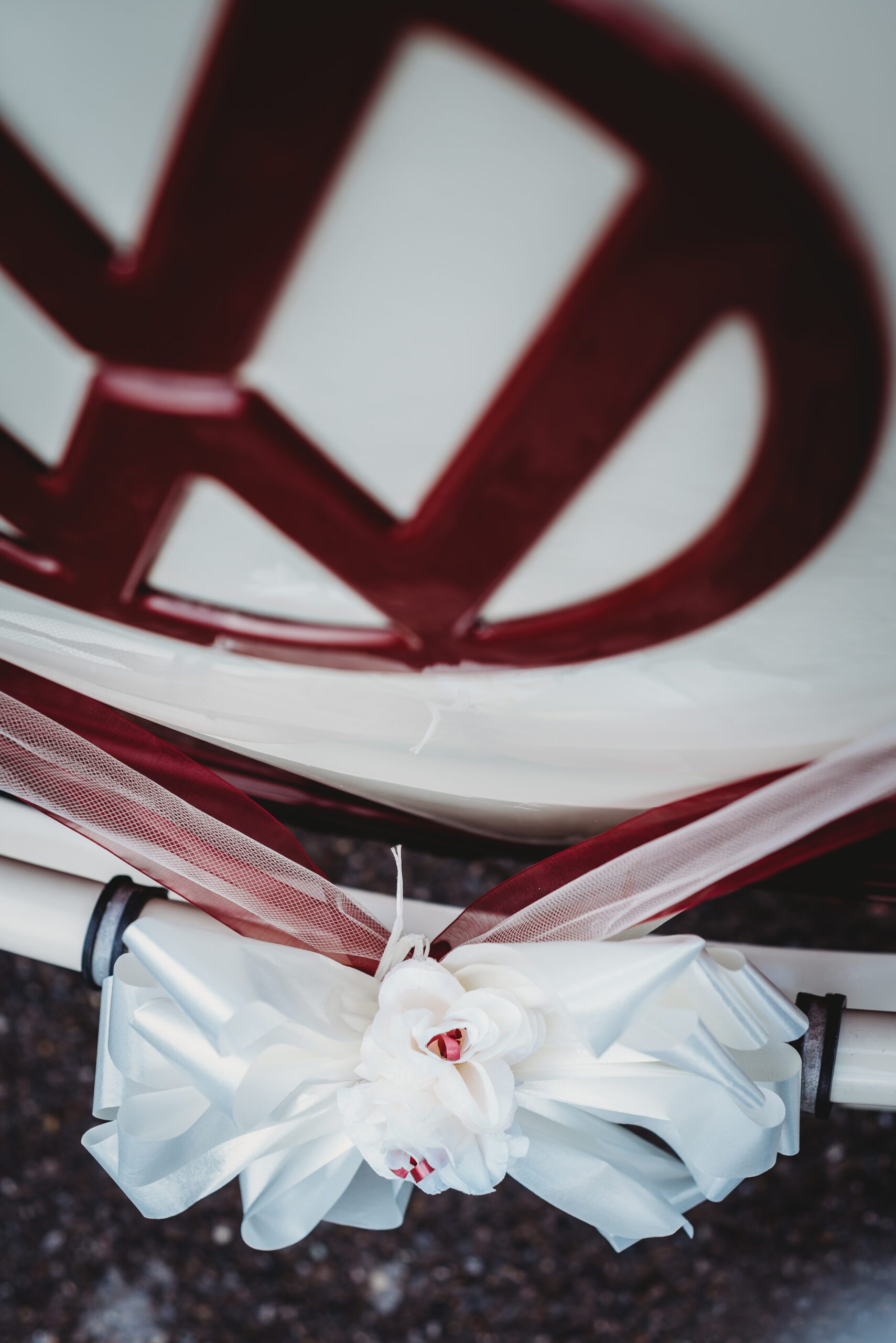 a close up of the vw sign on the front of the wedding transport 
