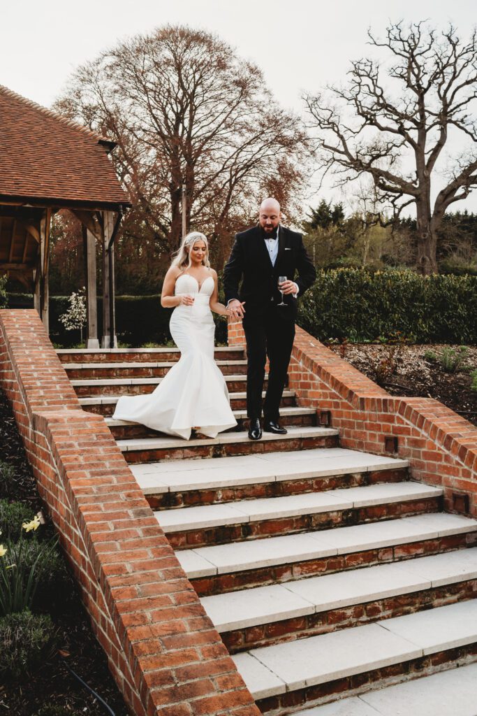 a newly wed bride and groom walking down steps 