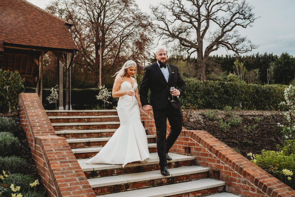 a newly wed bride and groom walking down steps 