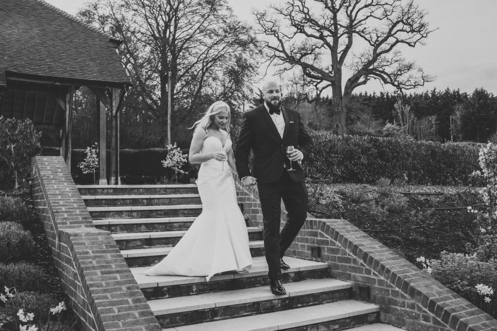 a newly wed bride and groom walking down steps 