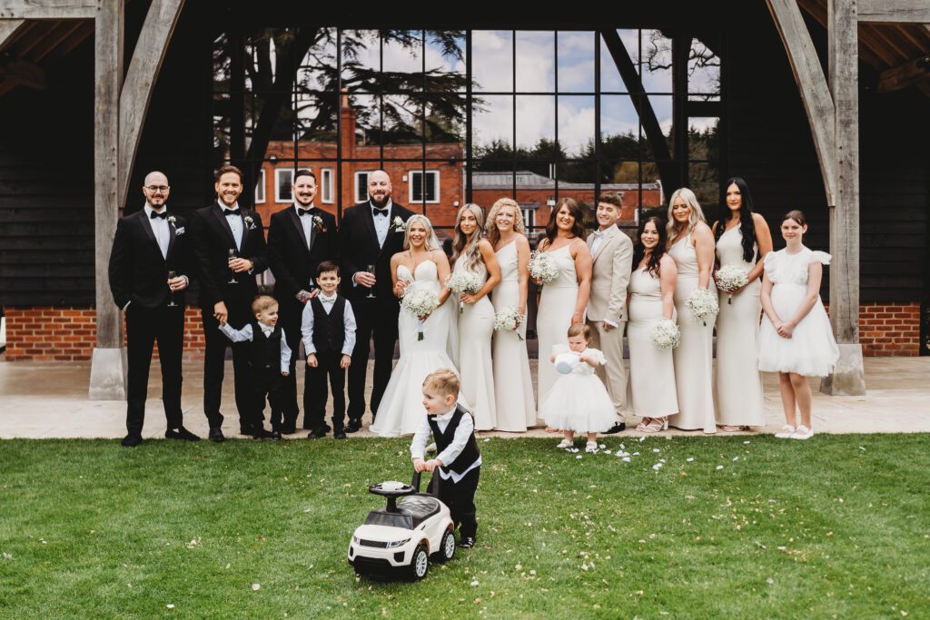 bride and grooms party lined up for a photo taken by a newbury wedding photographer 