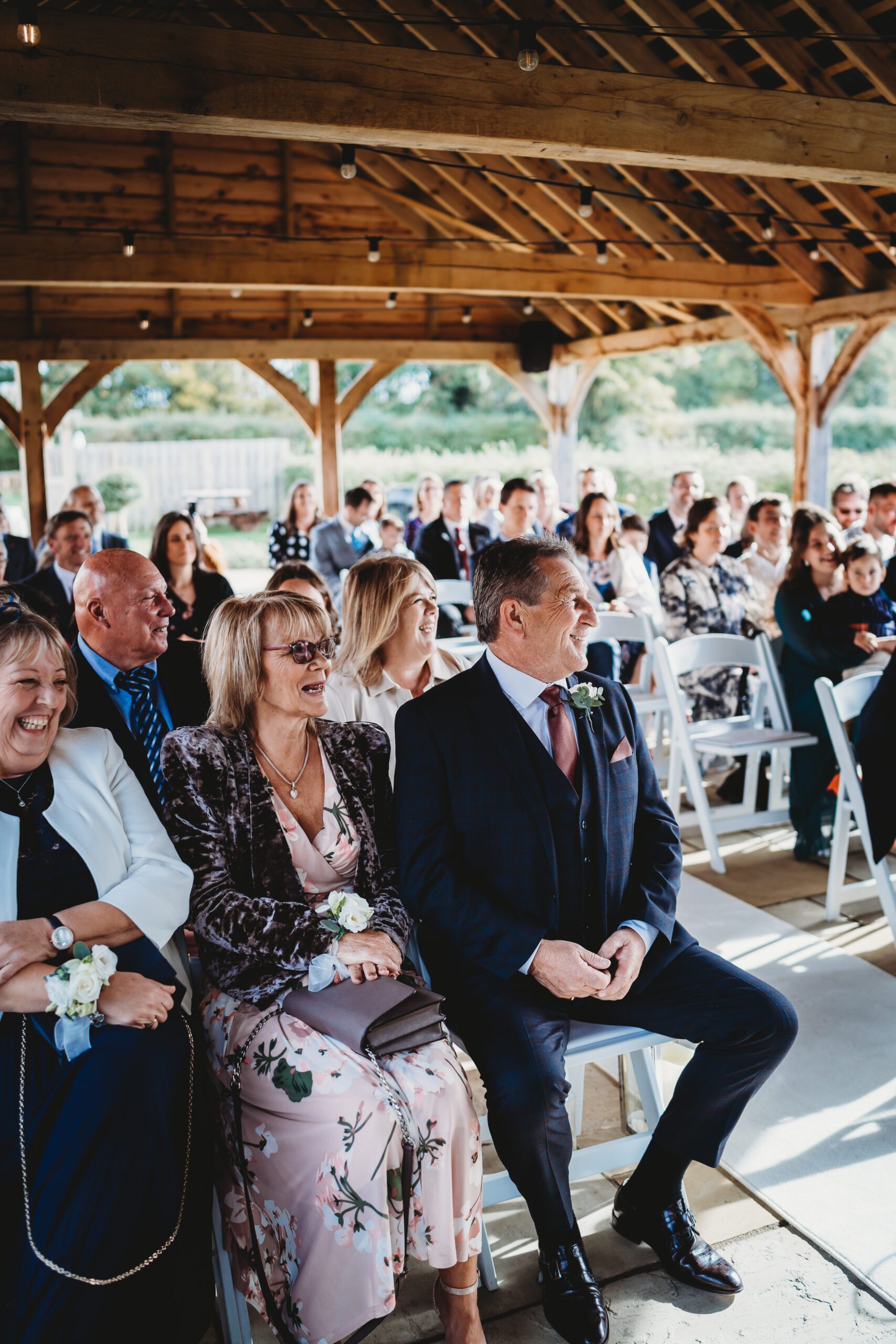 wedding guests laughing along with a courtyard autumn wedding 