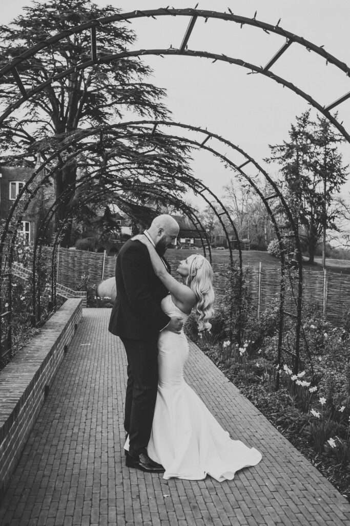 a bride and groom cuddling after their wedding ceremony