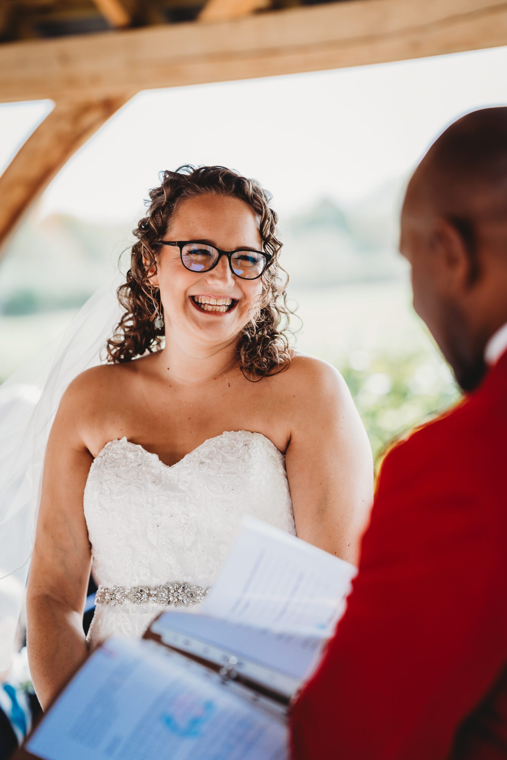 a bride laughing as shes getting married, taken by a hampshire wedding photographer 
