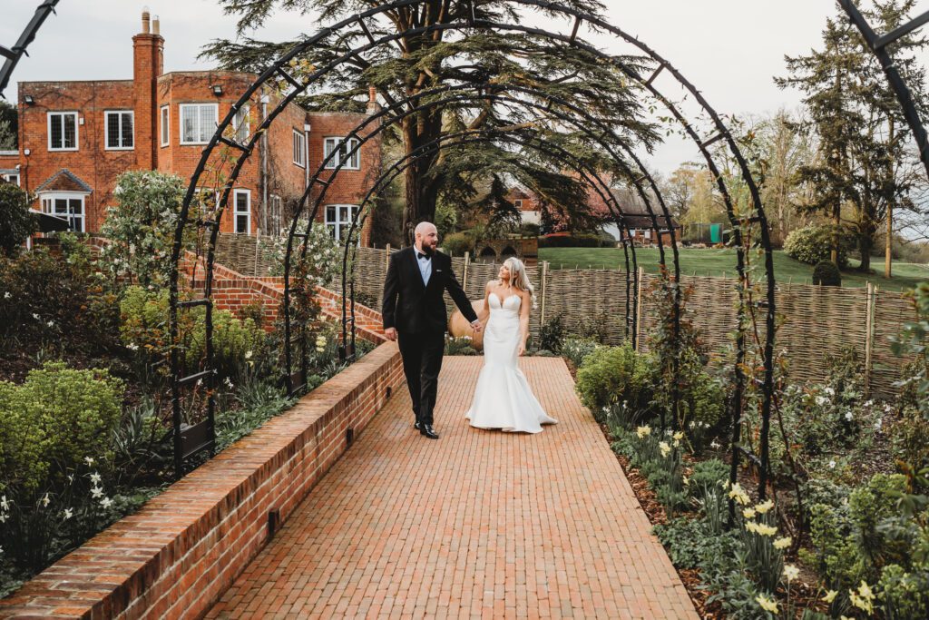 a bride and groom walking towards a newbury wedding photographer 