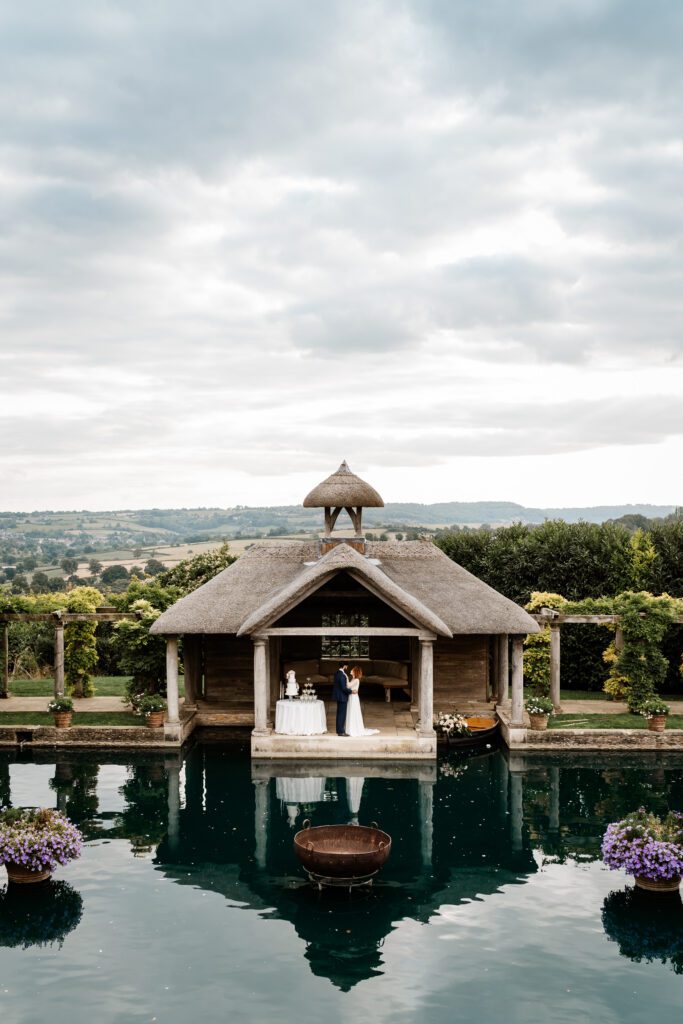 a bride and groom together after their ceremony in the Euridge Manor boat house 