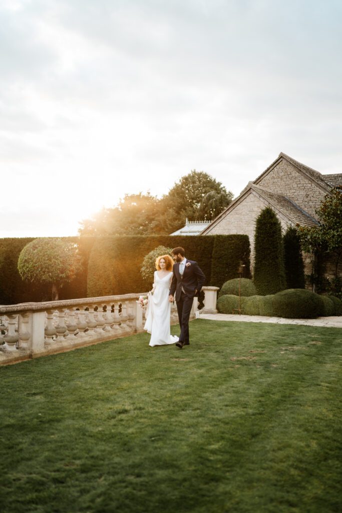 a sunset shot of a bride and groom walking together after their Euridge Manor wedding for a photographer 