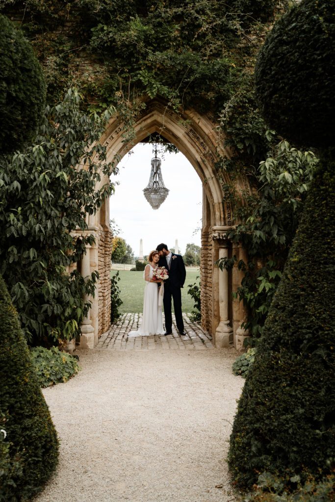 a bride and groom cuddling under an outdoor chandelier for a euridge manor wedding photographer 