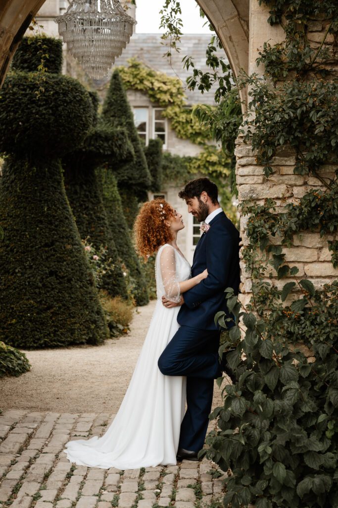 a bride leaning into her new husband after their Cotswolds wedding