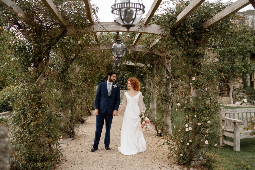 a bride and groom holding hands and looking at each other after their Euridge Manor wedding