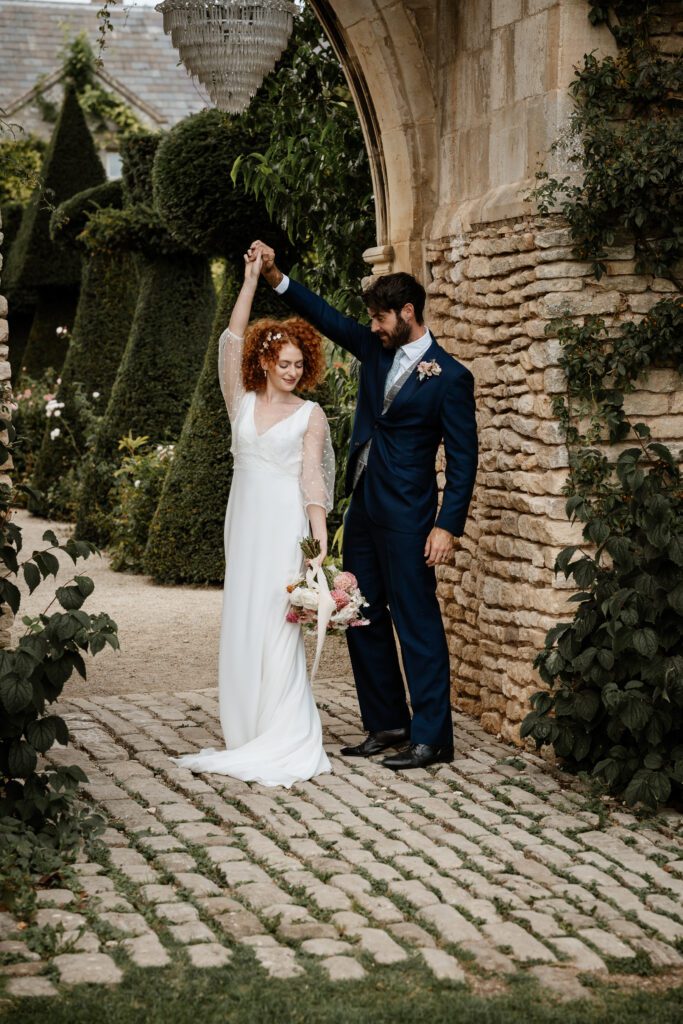 a bride and groom dancing following their cotswold wedding 