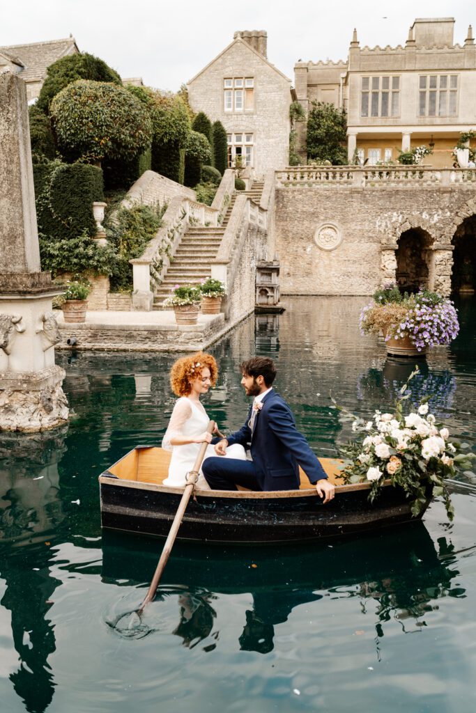 a bride and groom rowing a boat around a beautiful lake after their wedding taken by a euridge manor wedding photographer 