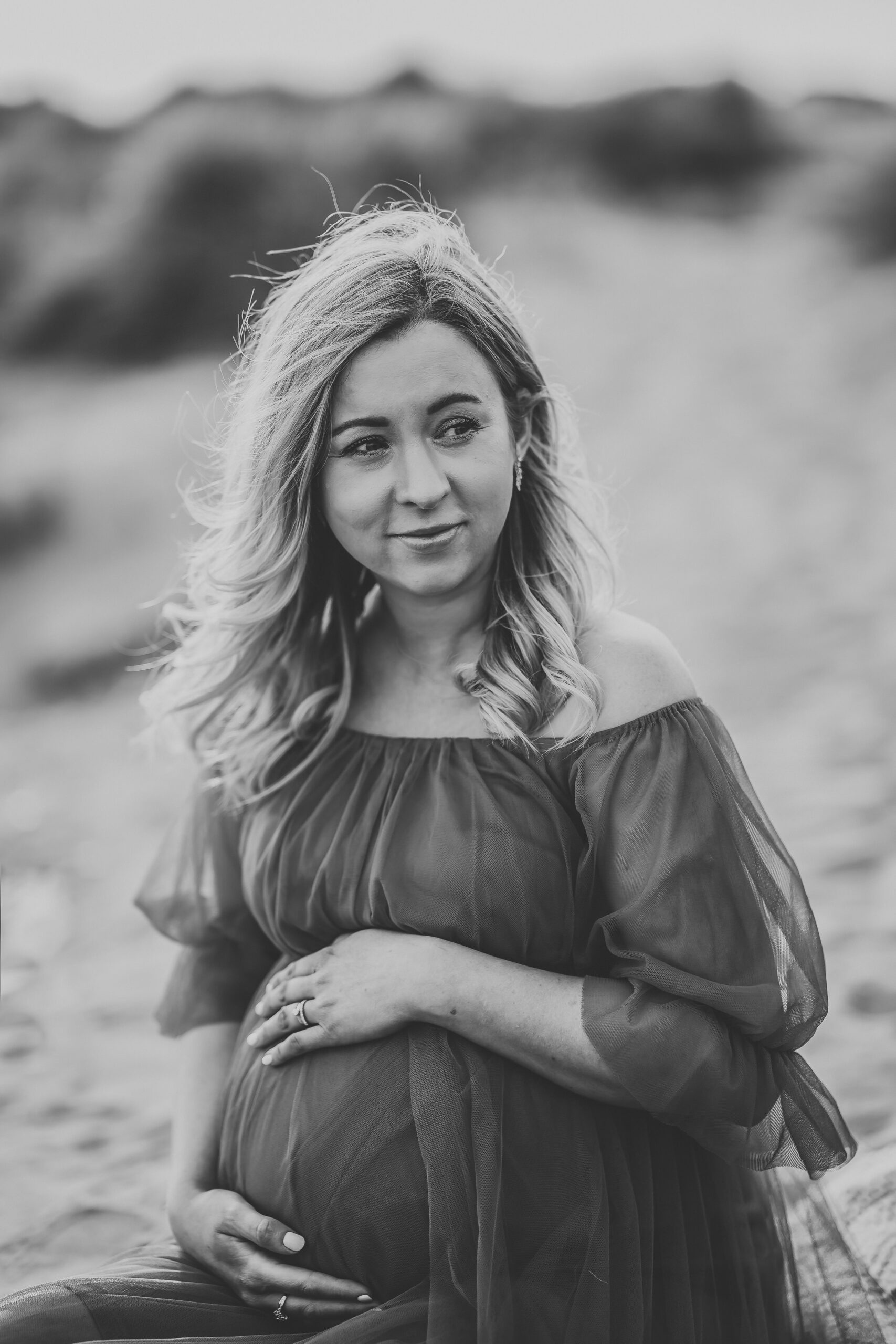 a close up image of a pregnant lady holding on to her bump taken by a newbury maternity photographer