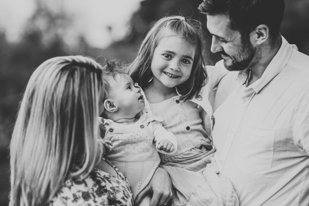 a close up of a family cuddling in close and laughing