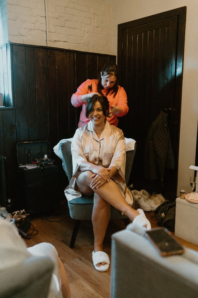 a bridesmaid having her hair done during bridal prep at a Newbury wedding venue