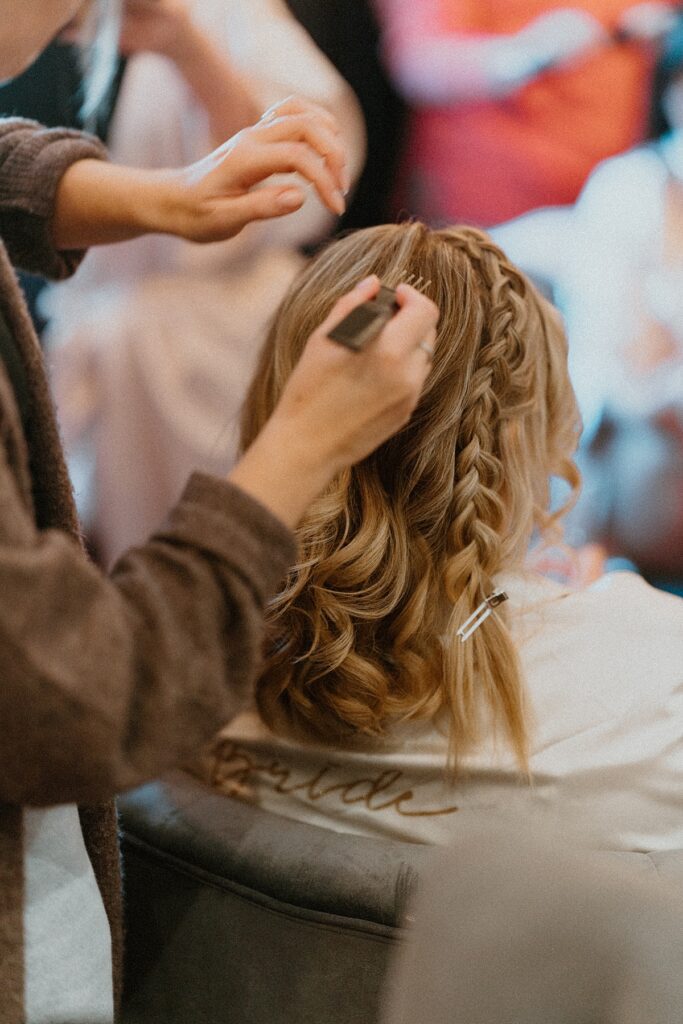 The bride having her hair done during her bridal prep at Ufton court Newbury