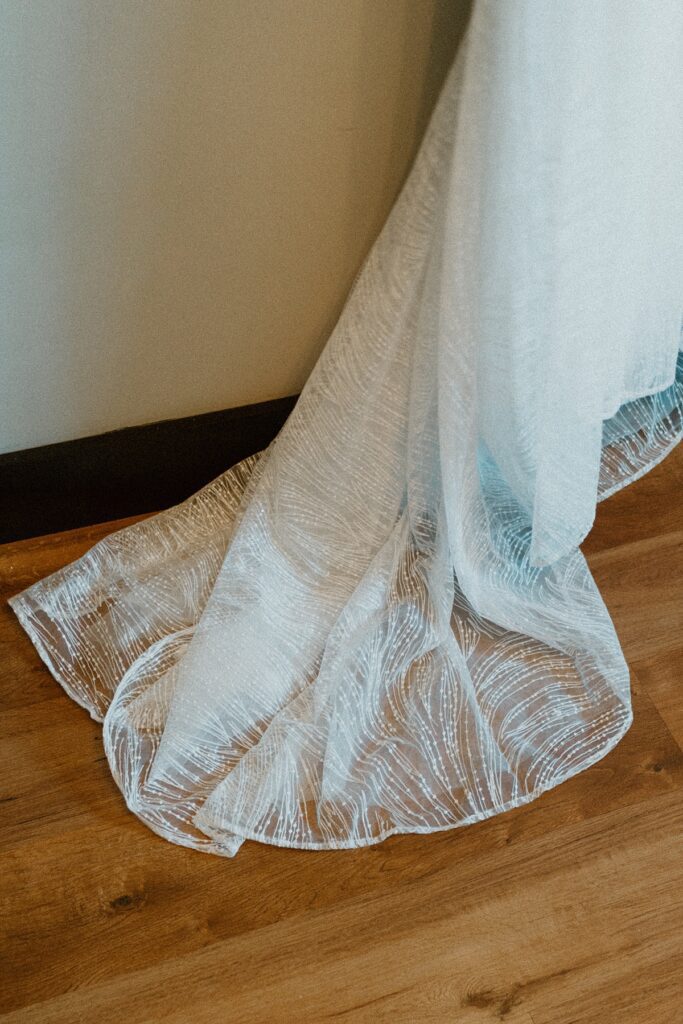 a details of the train of a bridal dress close up