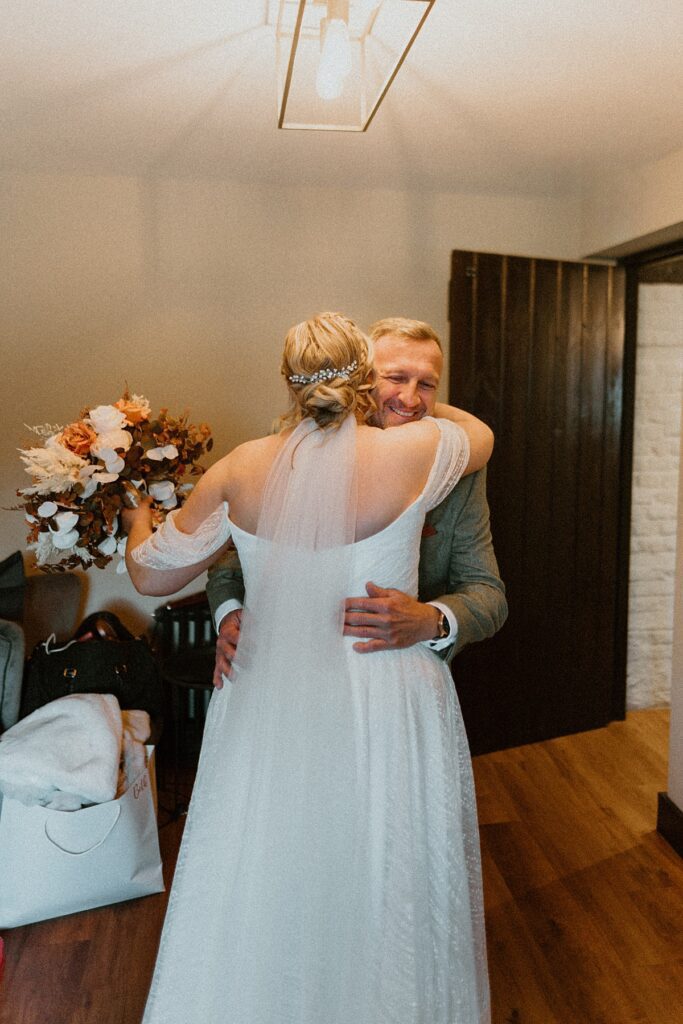 a dad hugging his daughter before she gets married at Ufton Court