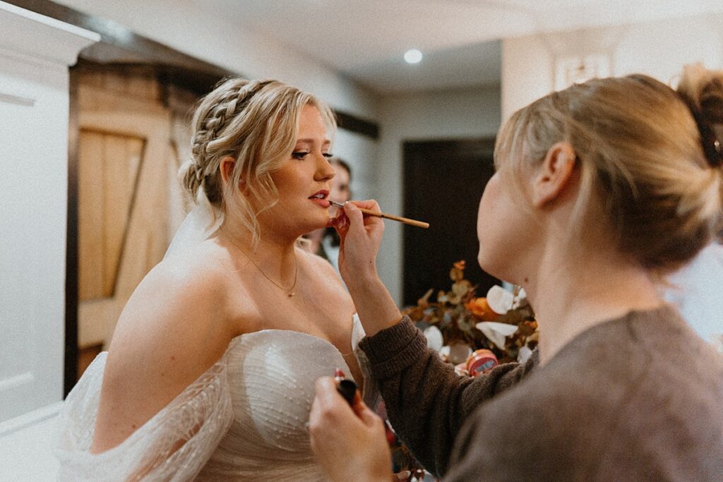 final touches being done by a make up artist during bridal prep at a luxury barn venue uk