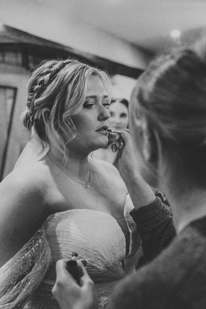 final touches being done by a make up artist during bridal prep at a luxury barn venue uk