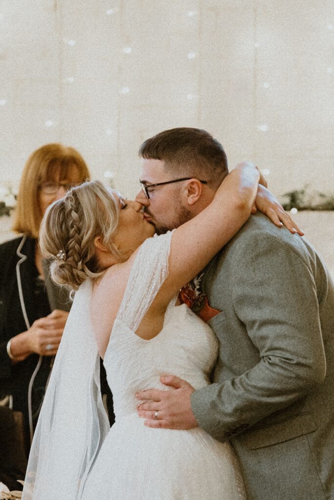 a first kiss as a husband and wife are declared as married at a Berkshire barn venue