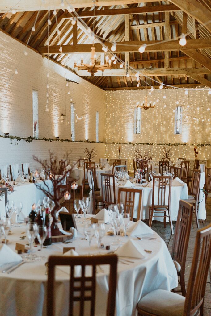 a fully decorated barn ready for a wedding breakfast at Ufton Court in the barn