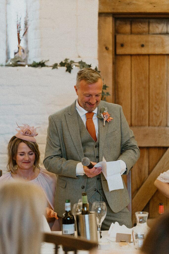 a father of a bride standing as he gives his speech at Ufton Court