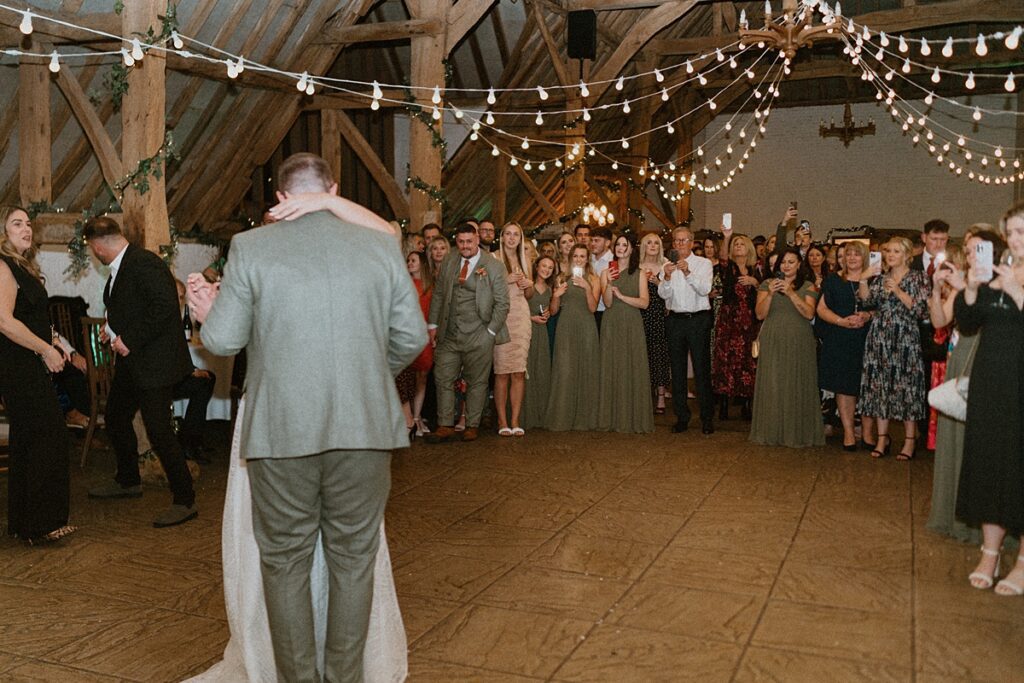 newly weds having their first dance at the barn at Ufton Court as the guests looked on