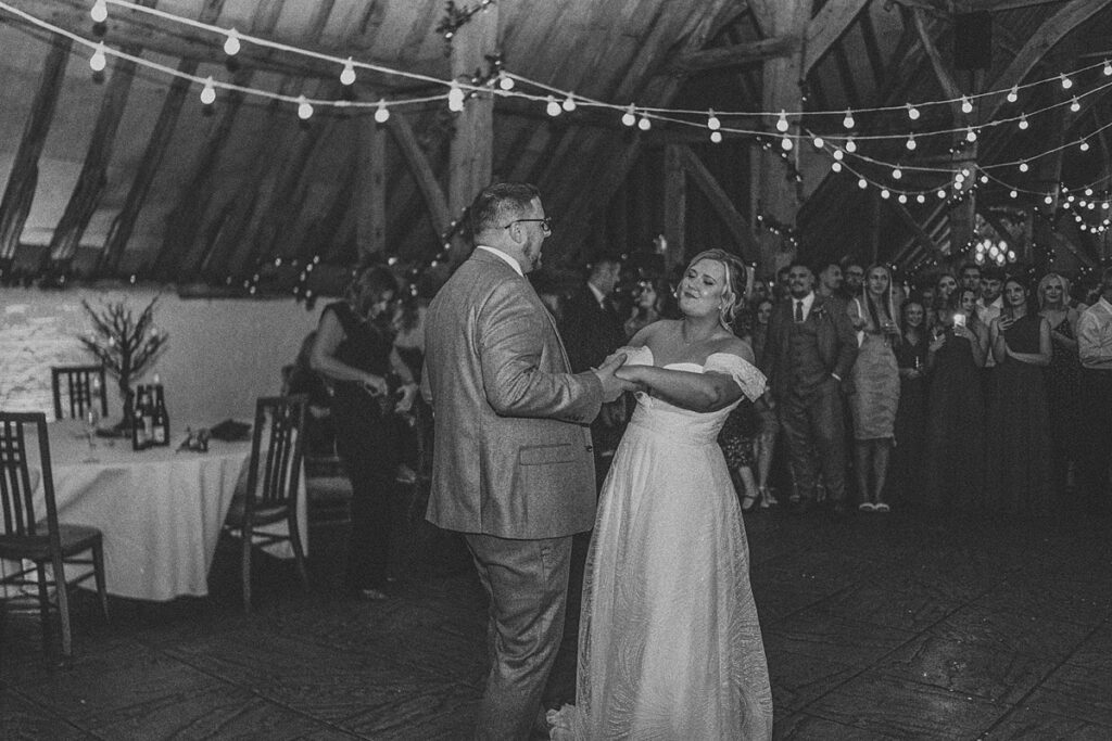 newly weds having their first dance at the barn at Ufton Court as the guests looked on